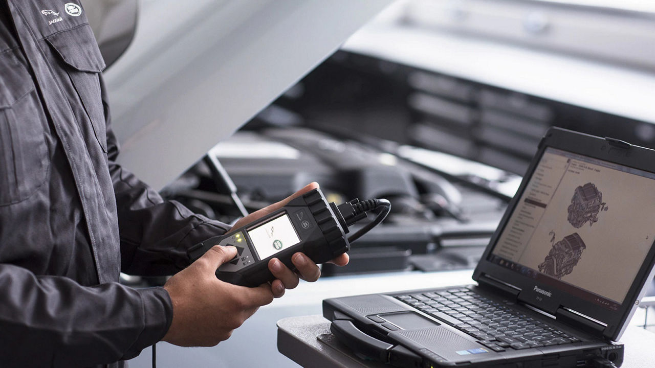 Land Rover staff check engine in laptop