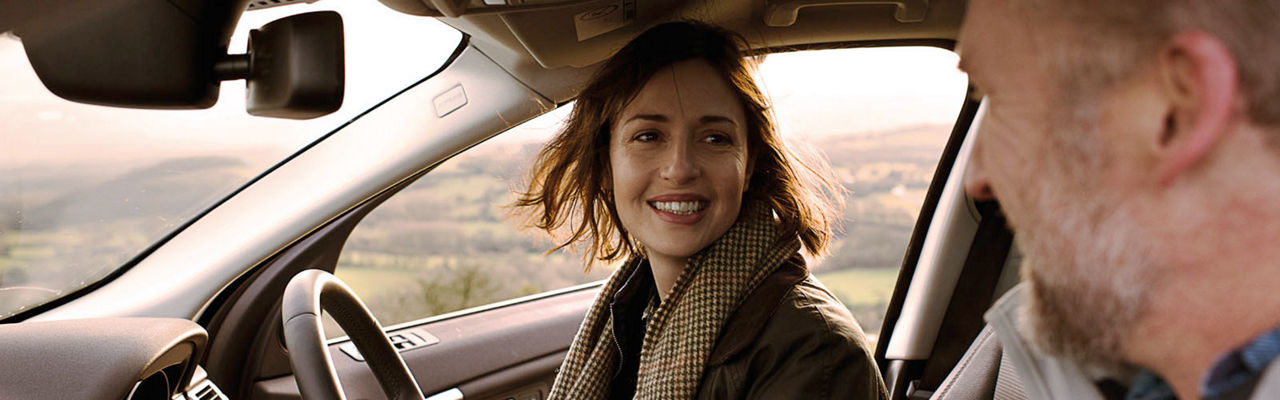 female is smiling in a Land Rover vehicle