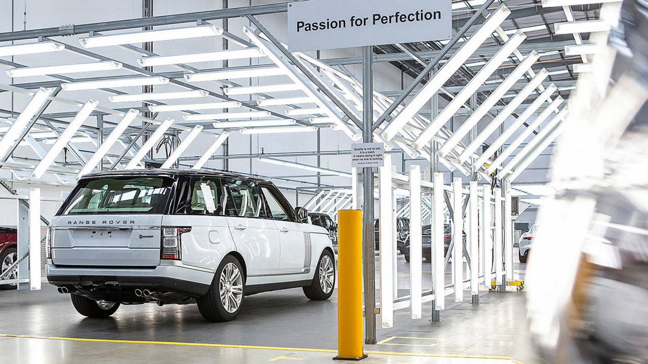 Range Rover in white into Land Rover facilities