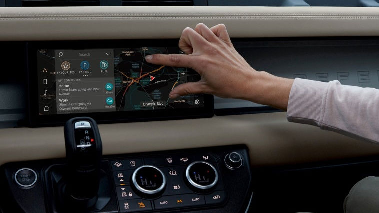 Person zooms in touch screen of a land rover vehicle