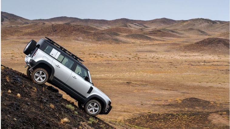 Land Rover Defender parked on a rock