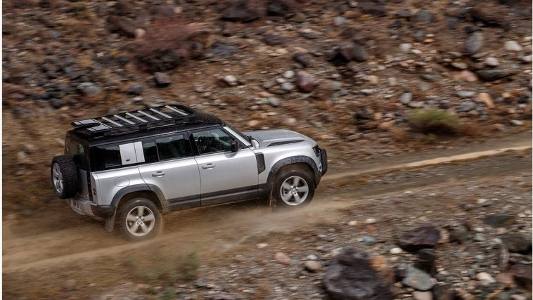 Land Rover Defender driving top side view