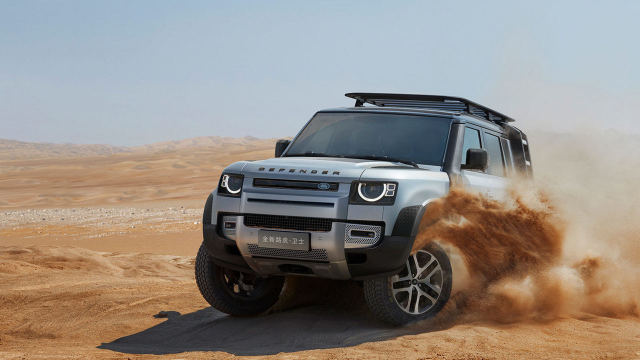 Land Rover Defender in sand front view