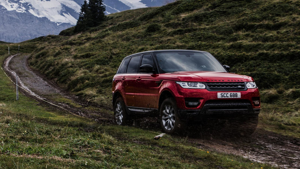 Range Rover driving in fields