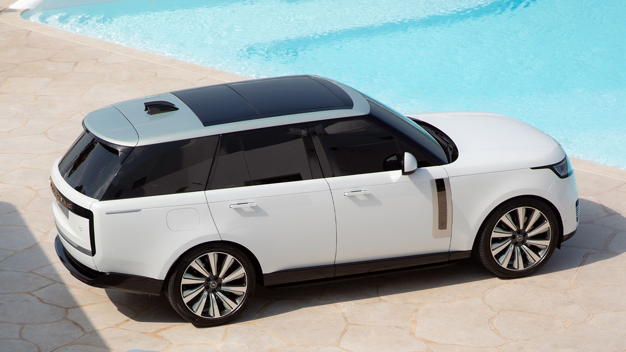 Range Rover parked besides swimming pool