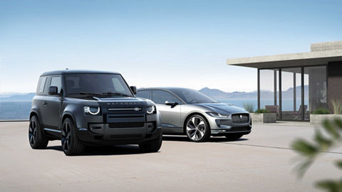 Land Rover and Jaguar with mountain background
