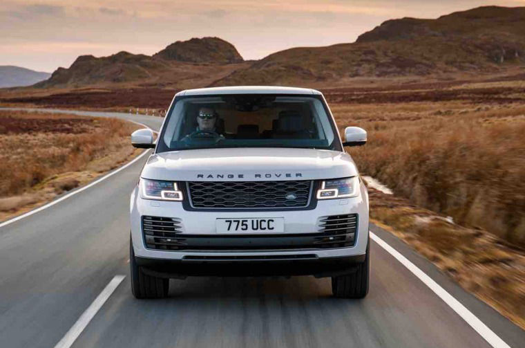 Range Rover driving down a road