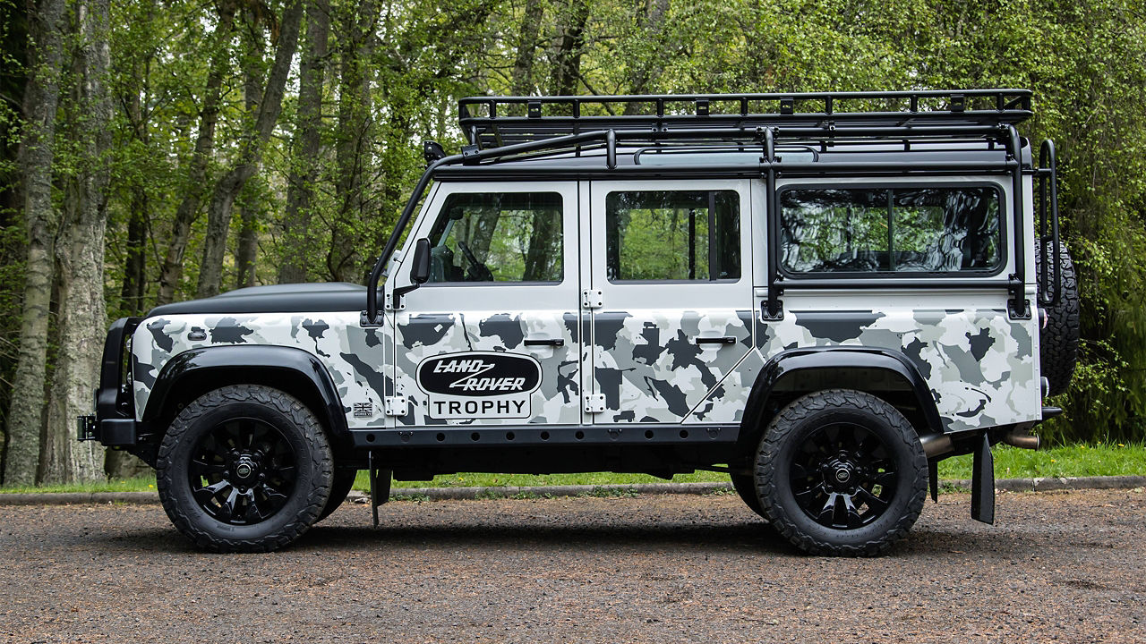Defender classic car near the trees