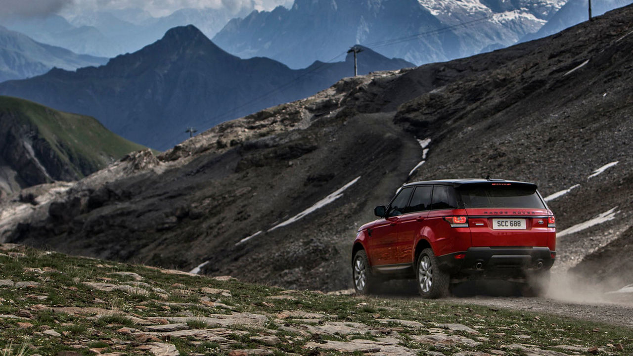 Red Range Rover driving through valley