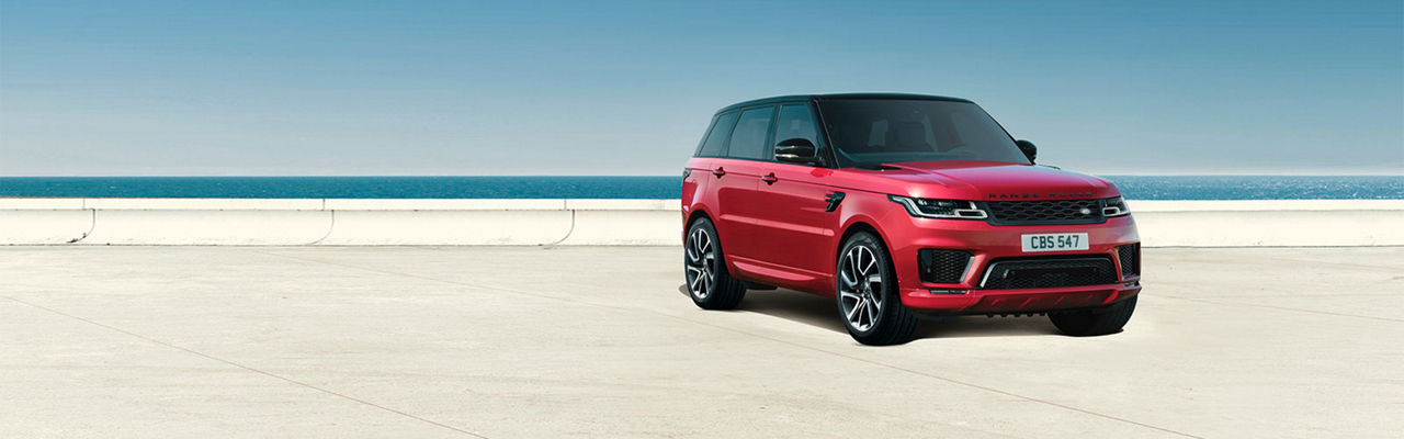 Range Rover Sport in red parked