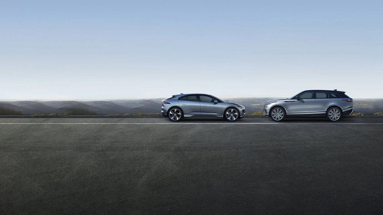 Jaguar Land Rover vehicles facing each other side view