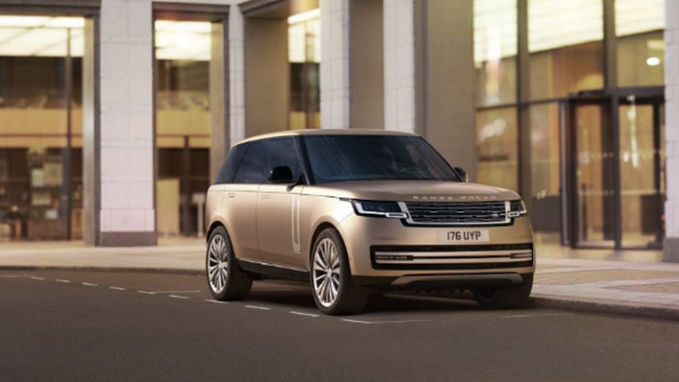 New Range Rover in gold parked front side view