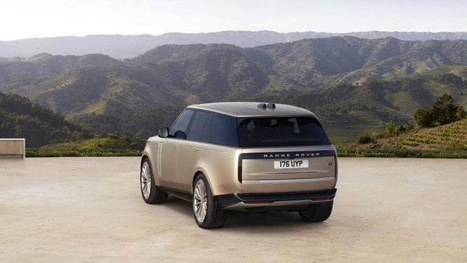 Range Rover in gold parked back side view