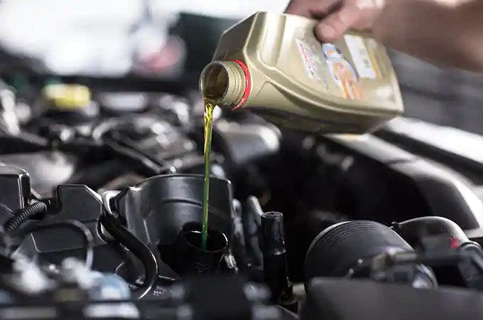 Oil getting poured into an engine