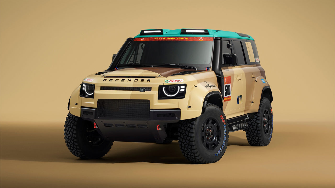 Front three-quarter view  of a Defender Dakar with desert livery displayed on a screen.
