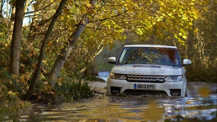 White Land Rover Vehicle driving in deep water