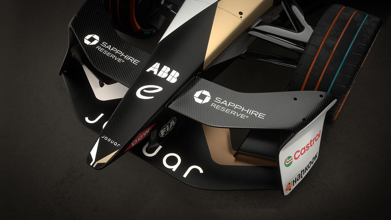 Close-up of the front wing of a Jaguar race car showing its sponsor logos.