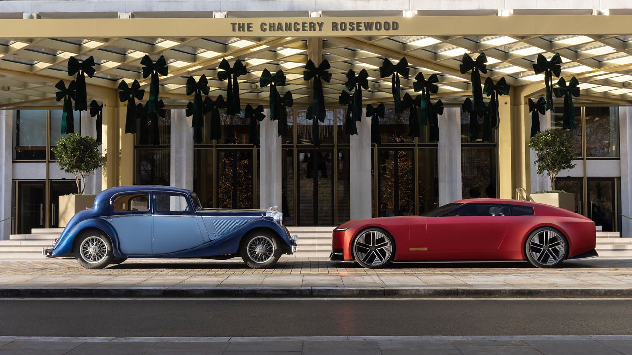 New future jaguar and old jaguar parked facing each other.