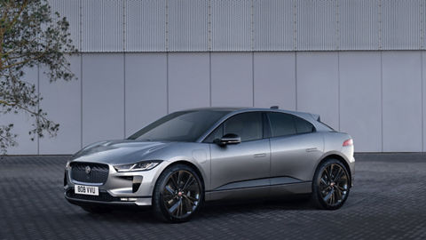 Jaguar I-PACE near the building and tree