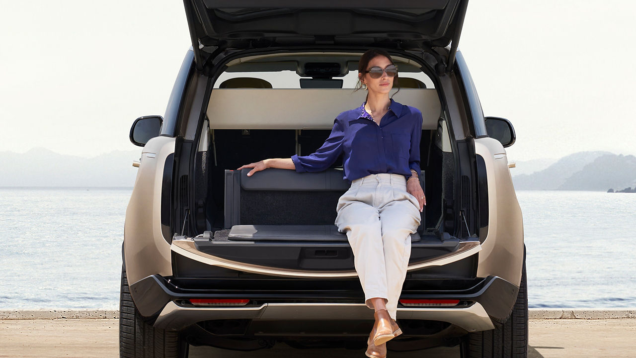 Emily Brooker sat in boot of Range Rover