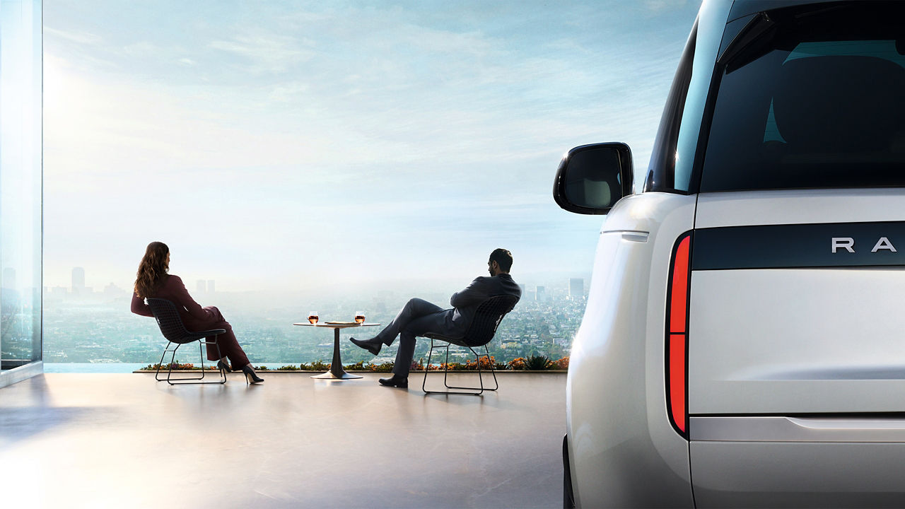 Range Rover parked half view with 2 people