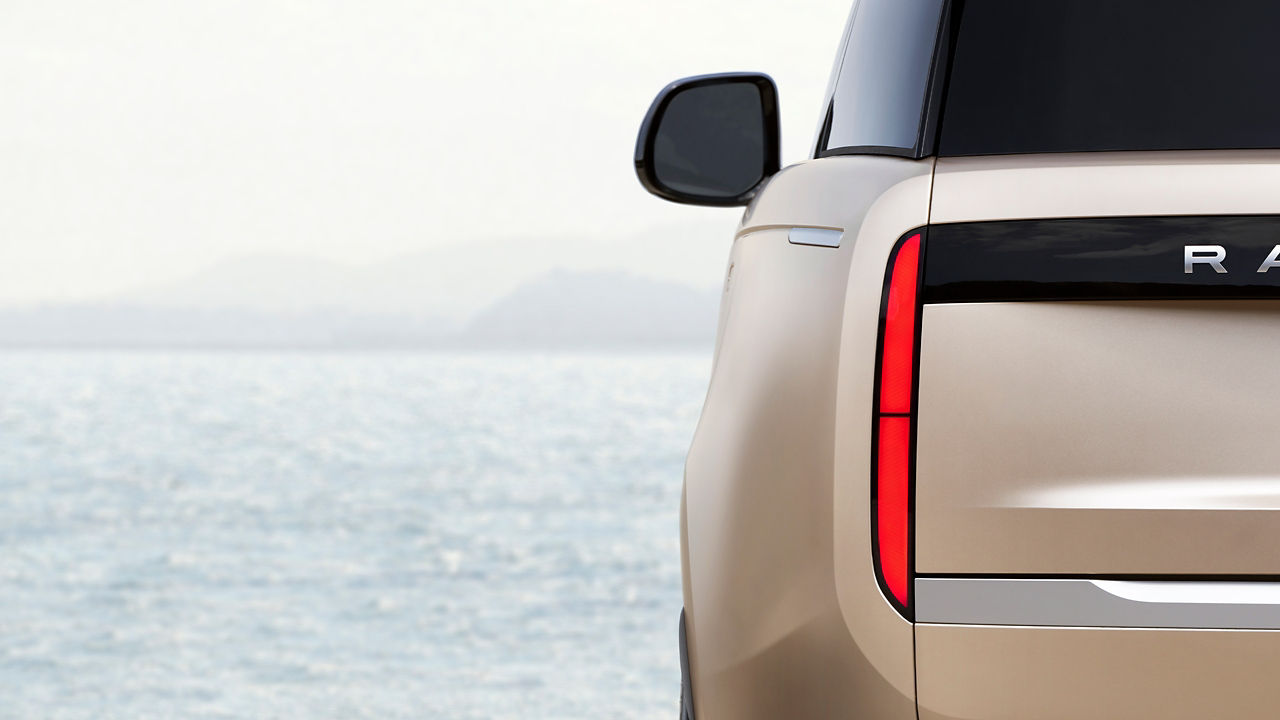 New Range Rover tail light parked near sea shore 