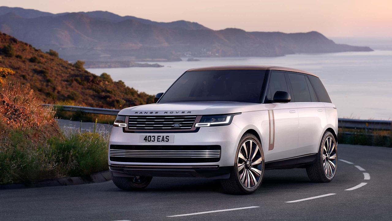 Range Rover SV in white driving in seaside background