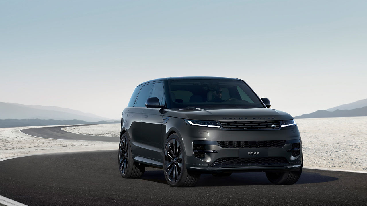 Front view of black Range Rover Sport on desert road.
