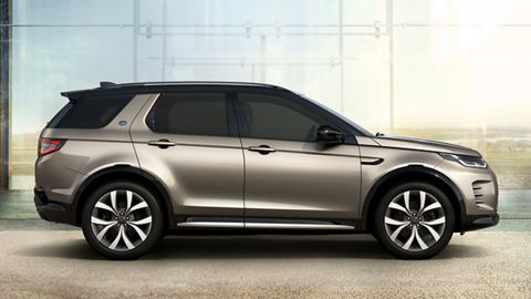 Parked Discovery Sport outside of glass house