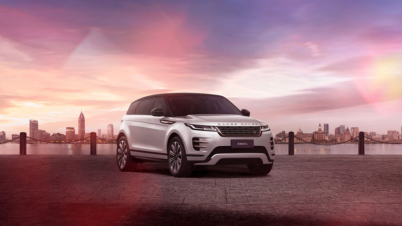 Range Rover Evoque Parked near sea line with city 