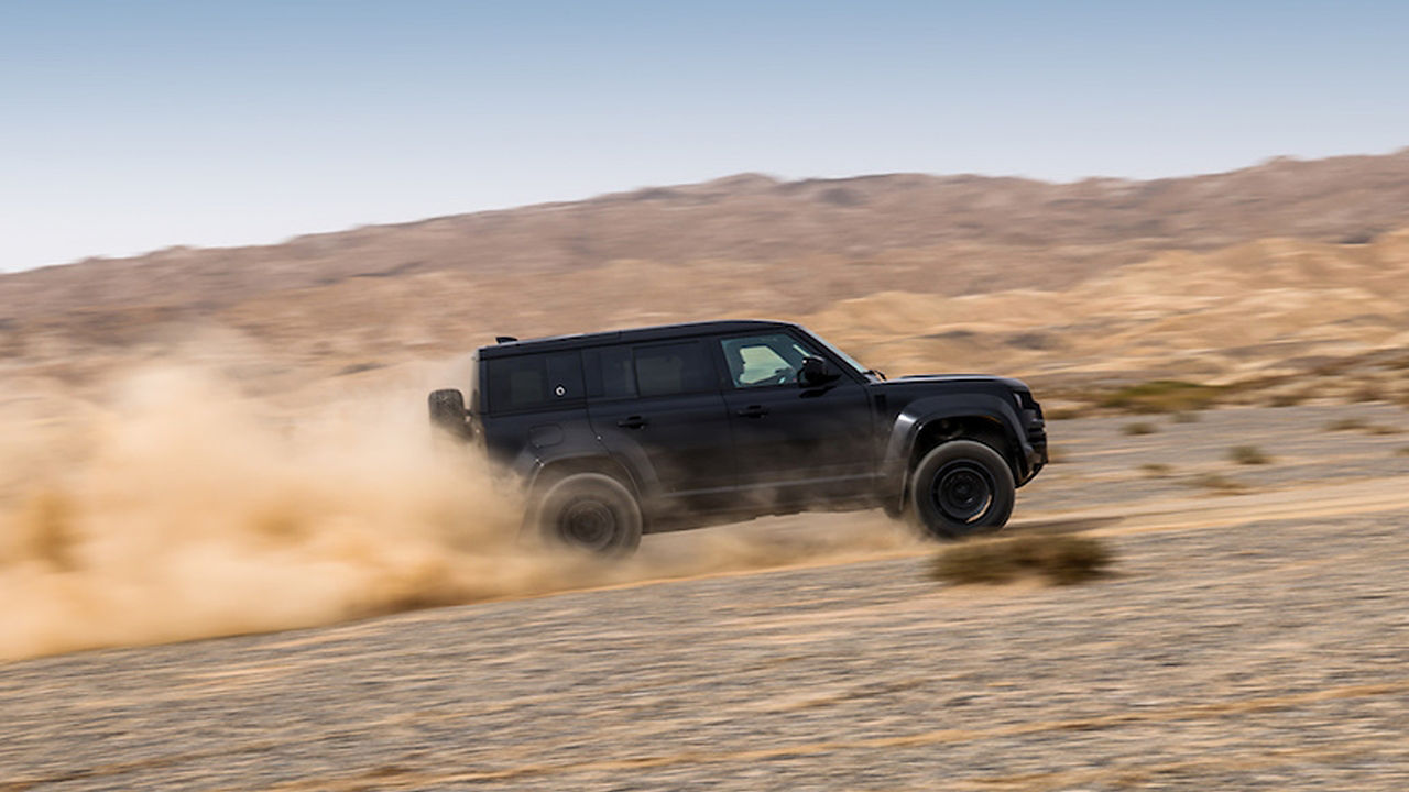 Black defender driving uphill