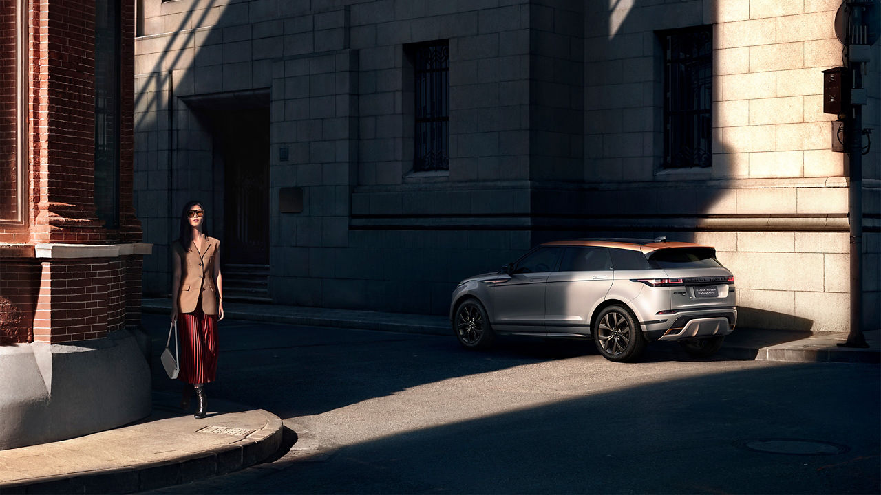 A girl walking near the Range Rover Evoque L