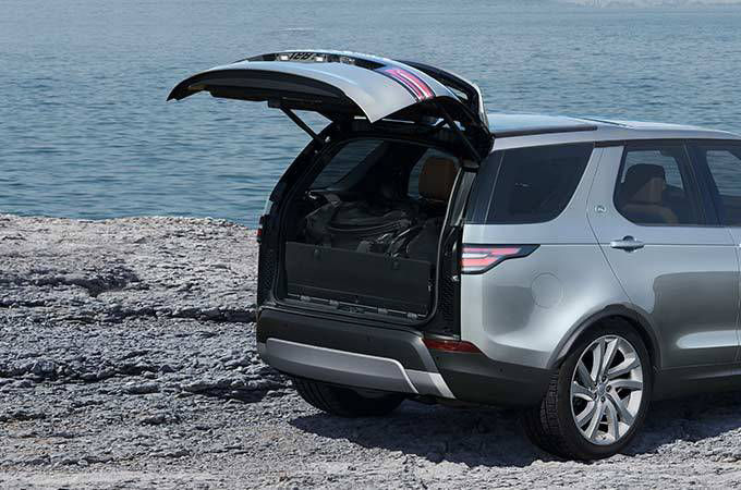 Land Rover Discovery by the sea with boot open