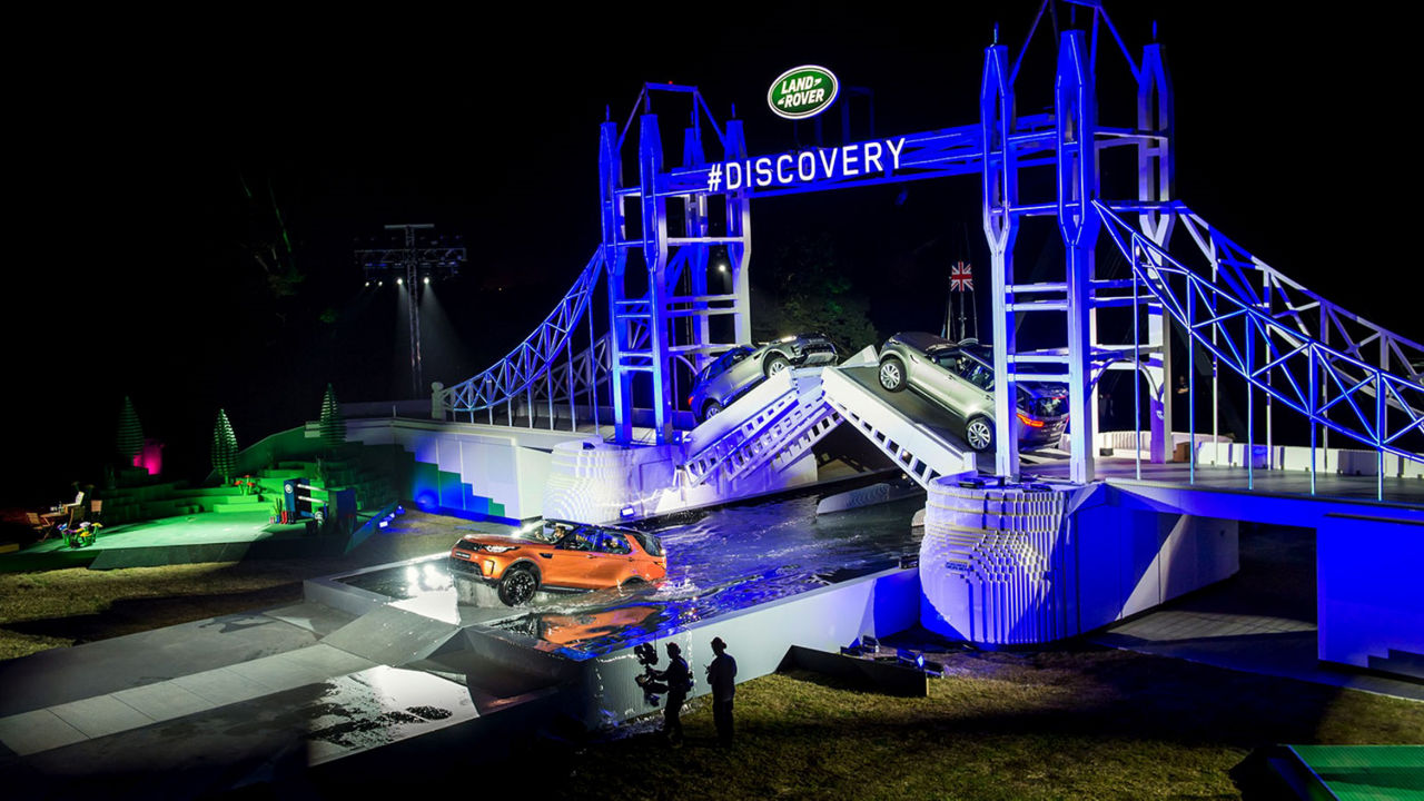 Land Rover Discovery driving through water on Discovery event stage