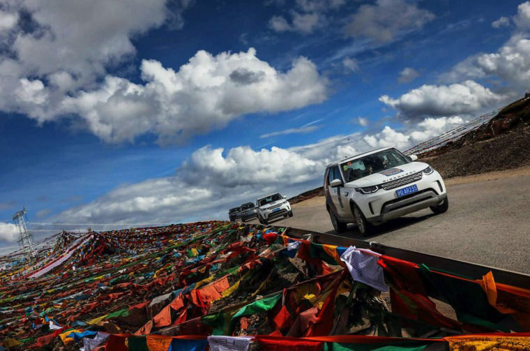 Land Rover vehicles driving on road