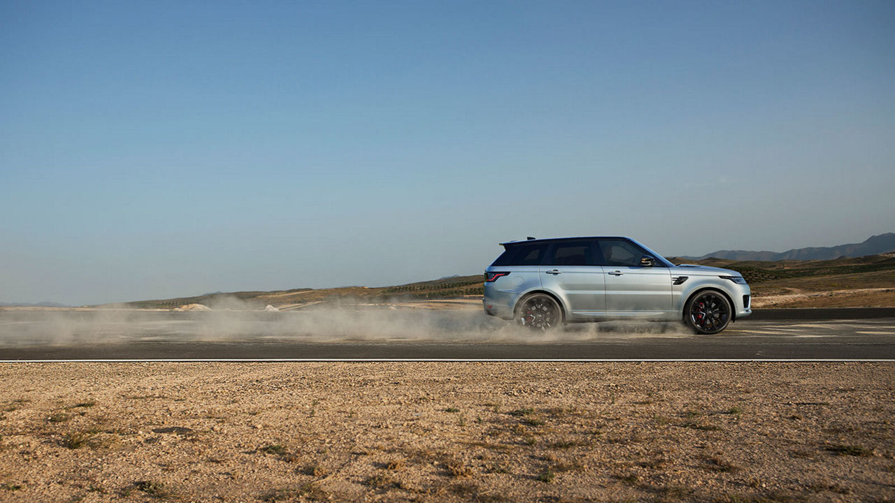 Range Rover driving on desert road