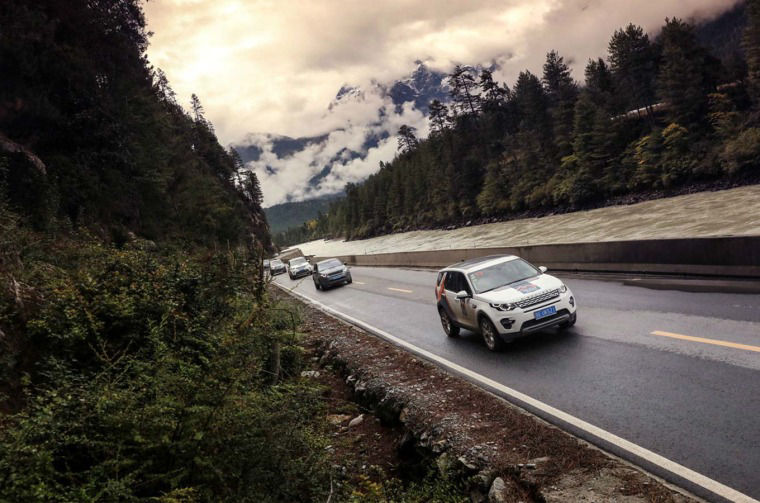 Land Rover vehicles driving on road