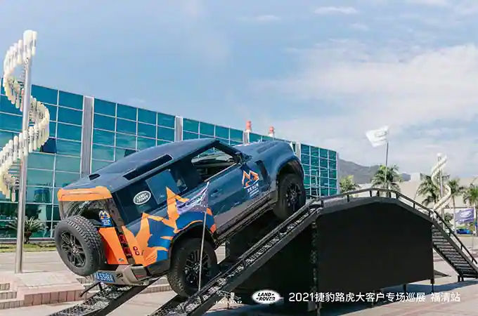 Land Rover Defender driving up ramp
