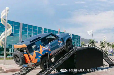 Land Rover Defender driving up ramp