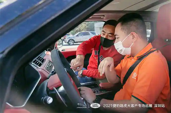 Men in Land Rover vehicle