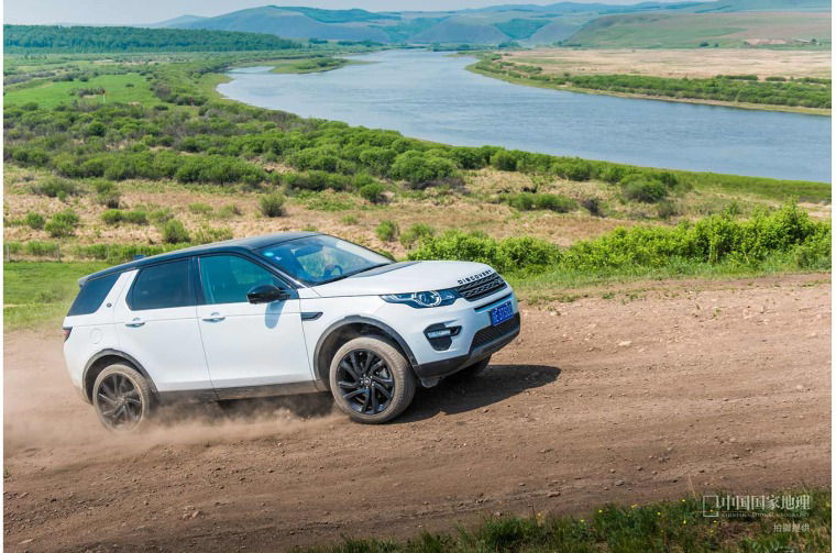 Range Rover driving on a dirt road
