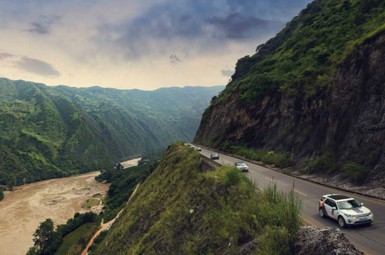 Land Rover vehicles driving on road through Nujiang Grand Canyon