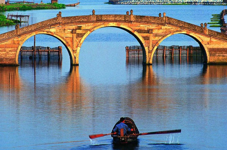 Boat going under bridge