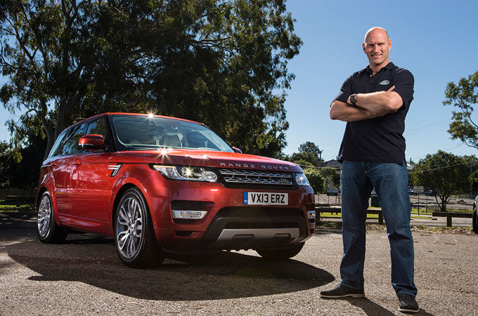 Man in front of Range Rover vehicle