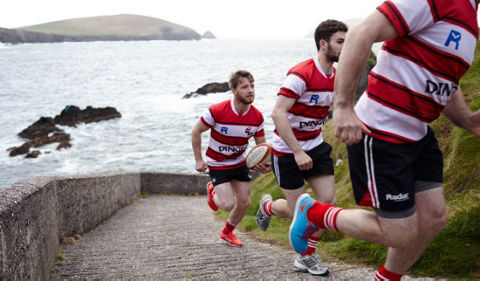 Rugby players running up walkway