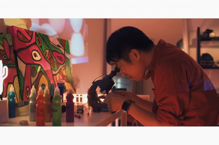 Male using Microscope 