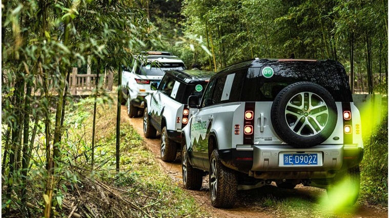 Land Rover vehicles driving on dirt road