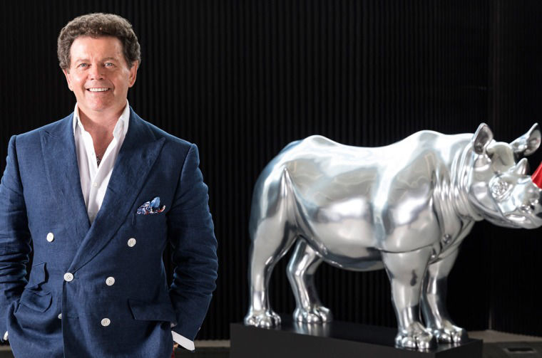 Gerry McGovern next to The Land Rover Rhino sculpture