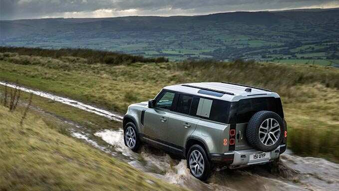 Land Rover Defender 110 driving through water