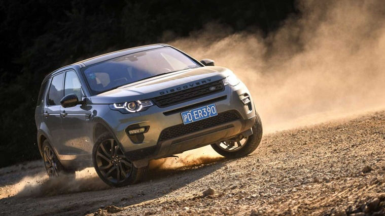 A Discovery drifting on a dirt road